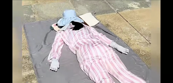 女子趁着35℃高温全副武装趴水泥地上晒背