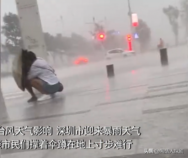 深圳大风暴雨市民撑伞蹲地寸步难行
