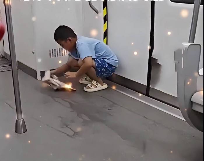 男孩饮品洒地铁家长以身作则清理