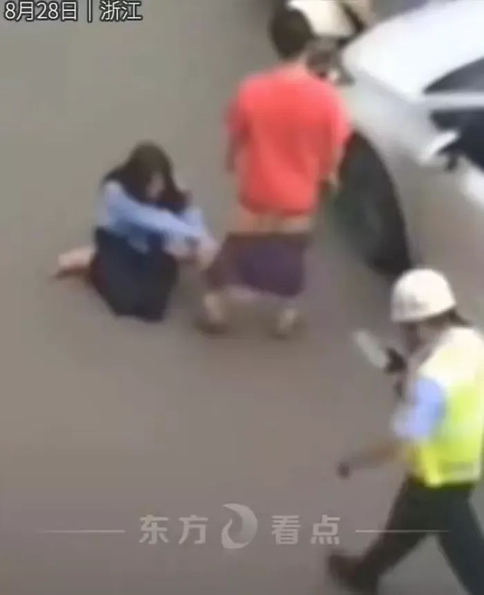 女子骑车撞轿车拿200元跪地求原谅